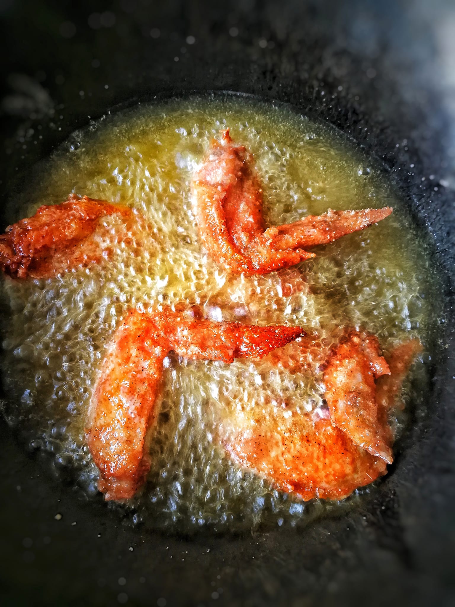 Fried chicken wings in the boiling oil